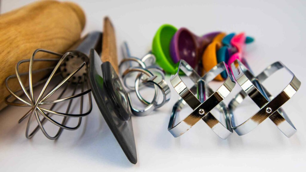 Cooking supplies viewed from their top ends gathered together on a white surface.